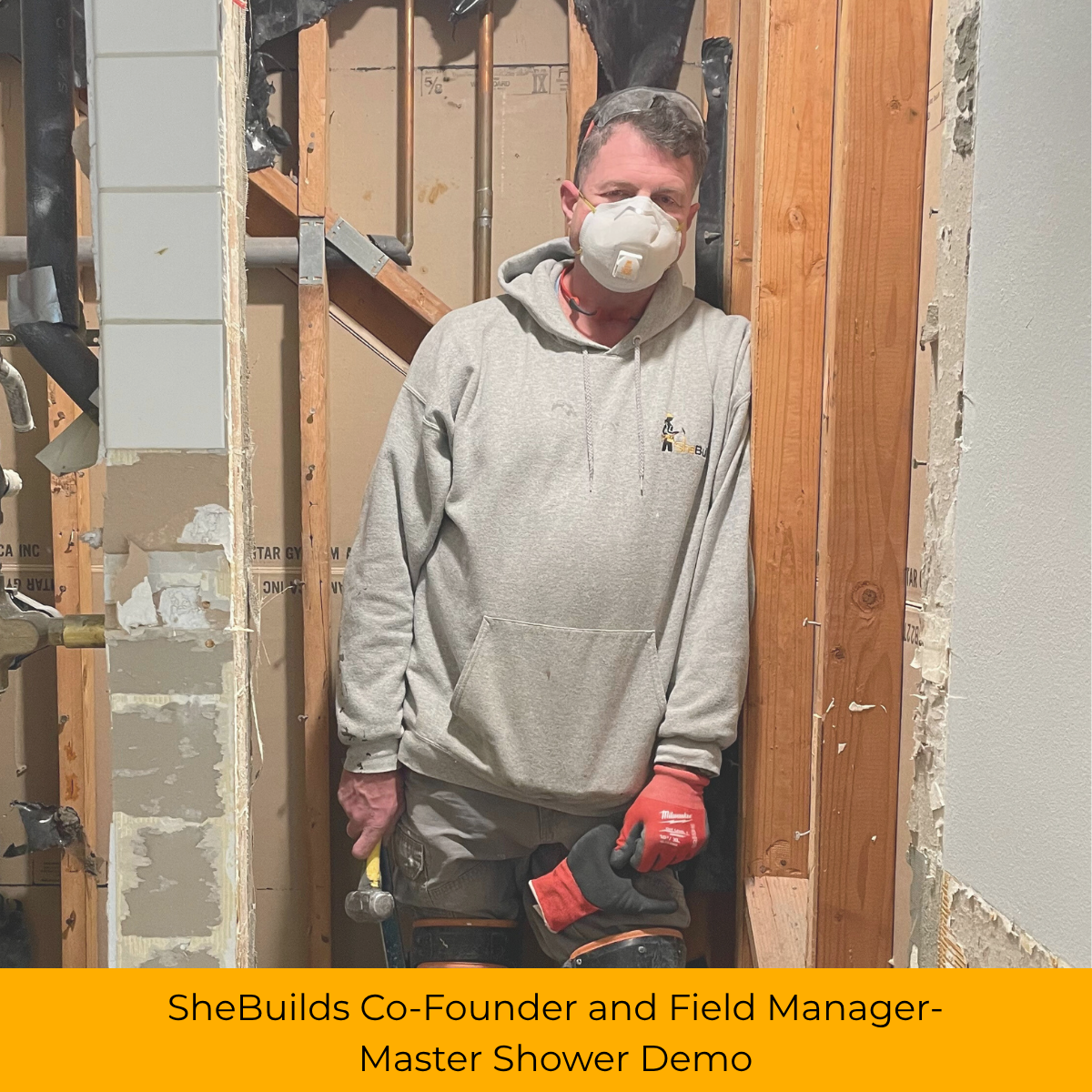 SheBuilds Co-Founder in a master shower he's demolishing preparing to renovate. 